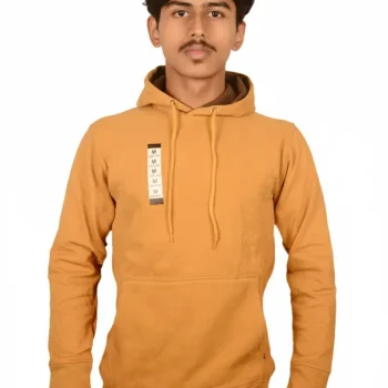 A person wearing a mustard-colored hoodie with a front pocket, standing against a plain white background.