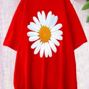 Red t-shirt with a large white daisy print on the front, lying flat on a textured surface.