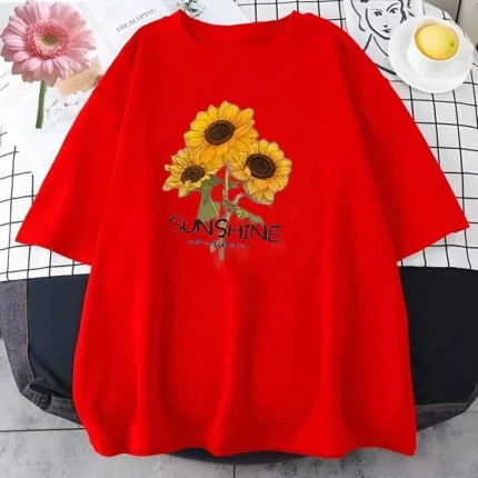 Red T-shirt with a sunflower design and the word "SUNSHINE" on it, displayed on a flat surface.