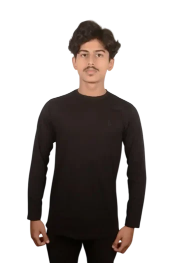 Person wearing a black long-sleeve shirt, standing against a black background with a neutral expression.